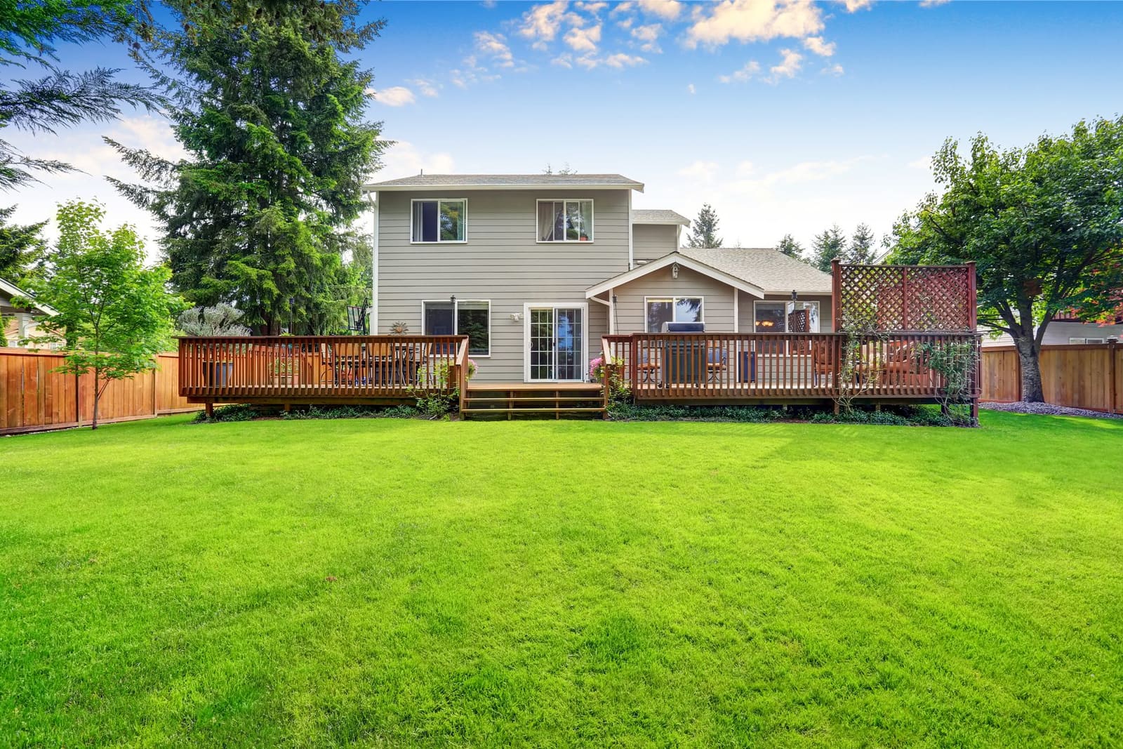 Keystone-listed home exterior: wooden deck and pergola off the back, photographed on the showing