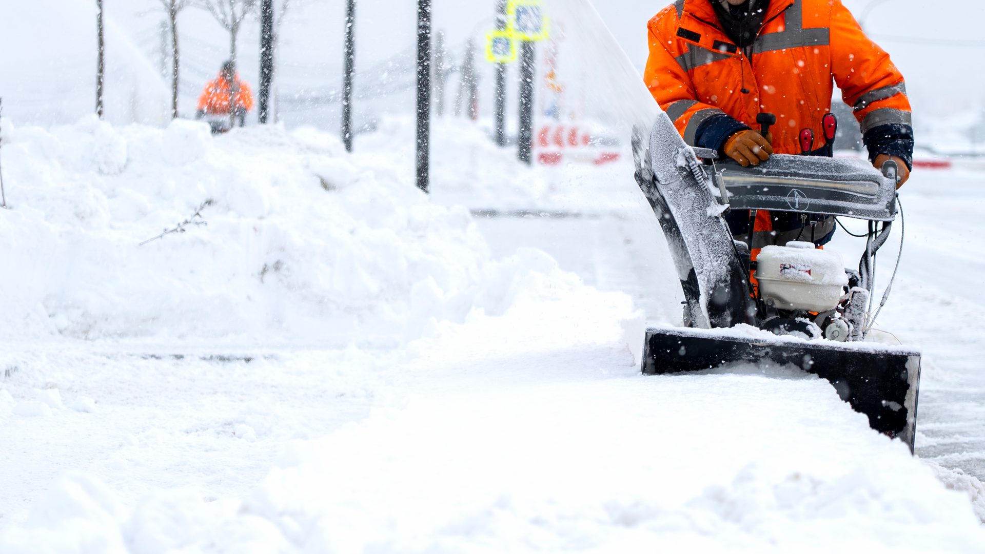 Northpoint crew member clearing an industrial lot with a snowblower through deep drifts
