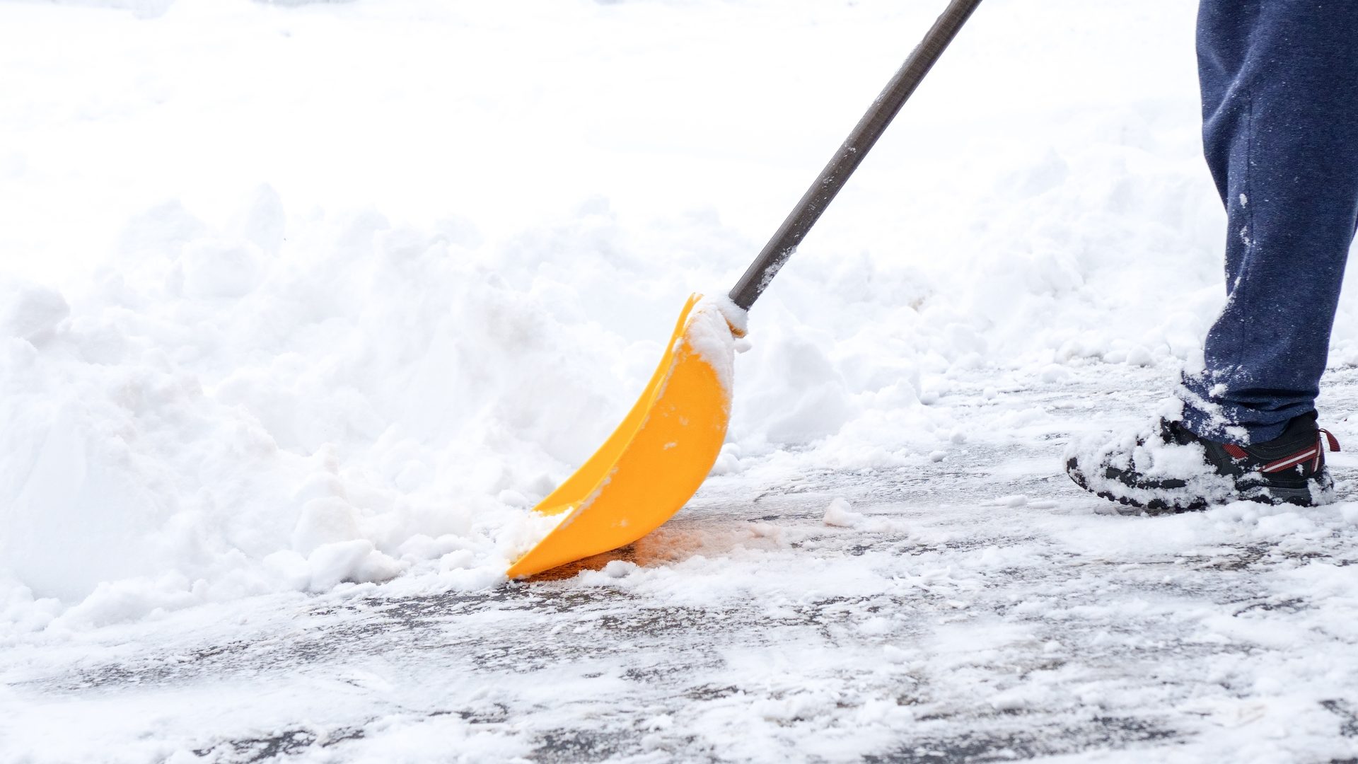 Northpoint crew member shoveling snow off a driveway after a storm