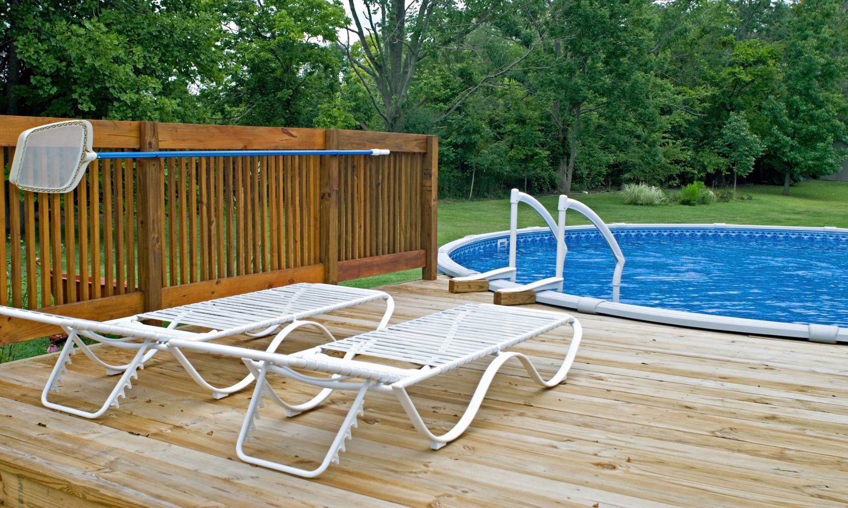 White loungers on a wooden pool deck